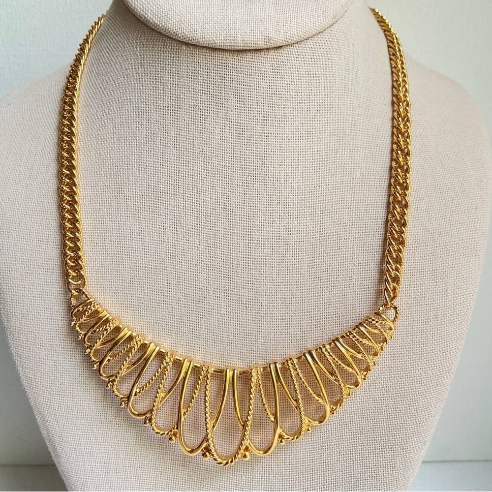 Avon vintage goldtone statement necklace with open loops on curved bar pendant